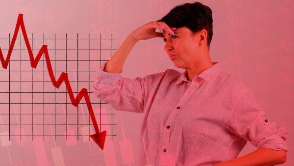 a woman looks stressed as her stock portfolio crashses